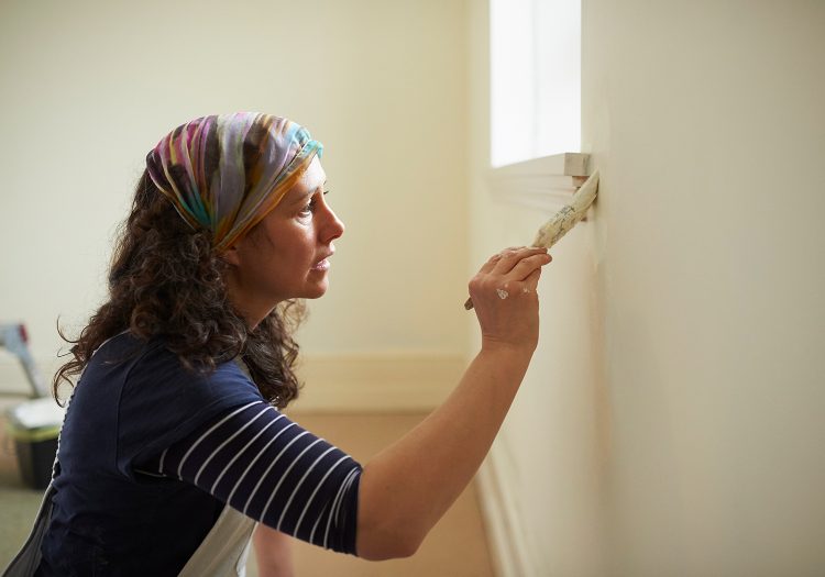 woman painting a wall