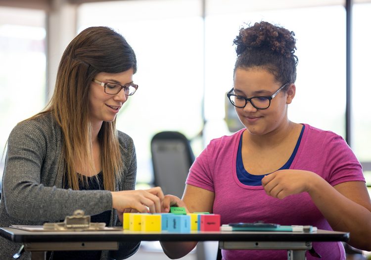 adolescent girl working with her female therapist