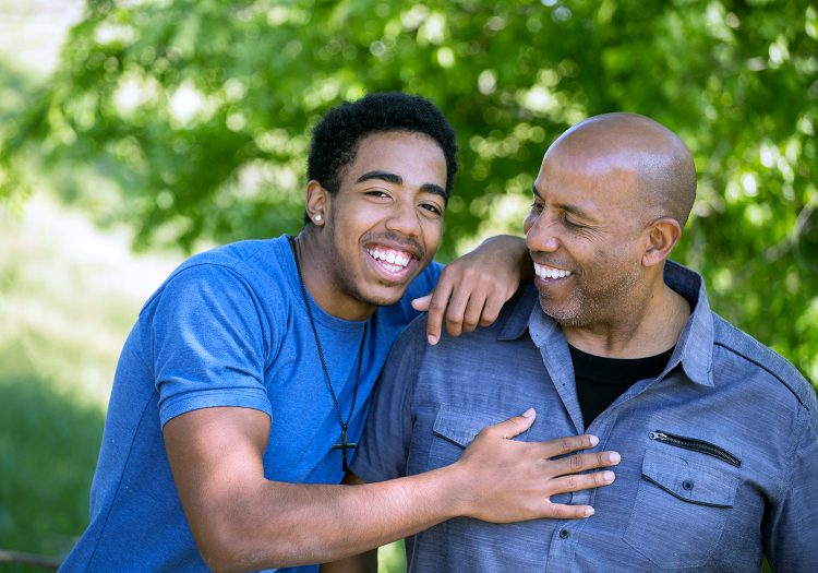 father and son smiling